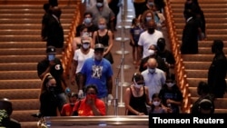 People pay their respects during the public viewing for George Floyd, whose death in Minneapolis police custody has sparked nationwide protests against racial inequality, at The Fountain of Praise church in Houston, Texas, June 8, 2020. 
