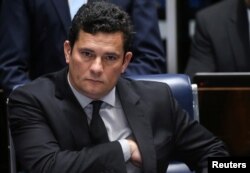 FILE - Brazilian federal judge Sergio Moro reacts during a session at the Federal Senate in Brasilia, Brazil, Dec. 1, 2016.