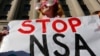 FILE - Member of the protest group, Code Pink, Cayman Macdonald protests against U.S. President Barack Obama and the NSA before the president's arrival at the Department of Justice in Washington, January 2014.