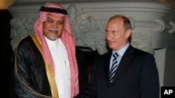 FILE - Russian Prime Minister Vladimir Putin greets Head of Saudi Arabia's National Security Council Prince Bandar bin Sultan.