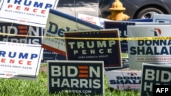 Transparenti "Trump-Pence" i "Biden-Harris" izloženi ispred biblioteke Coral Gabels Branch u Majamiju, Florida, 27. oktobra 2020.