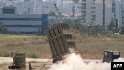 FILE - A missile is launched by an "Iron Dome" battery in Ashdod, Israel, July 11, 2014. Israel is looking to boost the amount of money the United States sends it every year for military aid to as much as $5 billion.