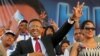 FILE - Hery Rajaonarimampianina (L) acknowledges the crowd with his wife Lalao (R) at anelection campaign rally in Antananarivo, Madagascar, in October 2013.