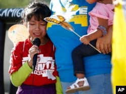 FILE - In this June 18, 2018 file photo, Akemi Vargas, 8, cries as she talks about being separated from her father during an immigration family separation protest in front of the Sandra Day O'Connor U.S. District Court building in Phoenix.