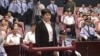 Gu Kailai (front, C), wife of ousted Chinese Communist Party Politburo member Bo Xilai, attends a trial in the court room at Hefei Intermediate People's Court, August 9, 2012