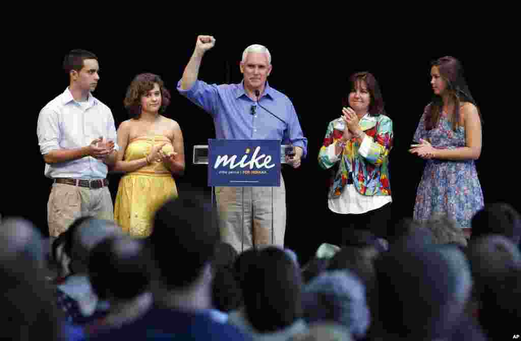 Rep. Mike Pence, center, surround by his family, left to right, son Michael, daughter Charlotte, his wife Karen and daughter Audrey as he kicked off his campaign for the Republican nomination for Governor of Indiana during a gathering of supporters in Columbus, Indiana, June 11, 2011. Pence promised to fight health care reform and federal climate change legislation. 