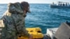 A U.S. Navy sailor conducts a search for debris of a high-altitude Chinese balloon shot down by the U.S. Air Force off the coast of South Carolina on Feb. 7, 2023. 3 more objects, downed the next week over the U.S. and Canada, remain unrecovered.