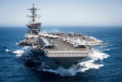 FILE - This U.S. Navy handout photo shows the aircraft carrier USS Theodore Roosevelt as it transits the Pacific Ocean while conducting a tailored ship’s training availability off the coast of Southern California, April 30, 2017.