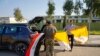 Christians volunteers hold Iraqi and Vatican flags as they decorate streets ahead of the planned visit of Pope Francis, in Qaraqosh, Iraq, Feb. 22, 2021. 