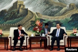 FILE - Philippines President Rodrigo Duterte (L) and Zhang Dejiang, Chairman of the Standing Committee of the National People's Congress of China hold a meeting at the Great Hall of the People in Beijing, Oct. 20 2016.