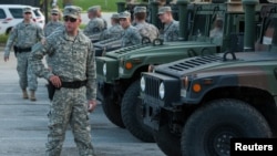 FILE - Anticipating a grand jury ruling, Missouri’s governor has declared a state of emergency. The declaration would activate the National Guard, whose members aided law enforcement during demonstrations in Ferguson in August.