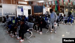 FILE - Guinean migrants wait at the airport before being deported to Guinea, in Misrata, Libya, Dec. 27, 2017.