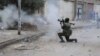 FILE - A Libyan military soldier fires his weapon during clashes with Islamic extremist militias in Benghazi, Libya, Oct. 30, 2014. 