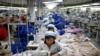 FILE - North Korean employees, shown in December 2013, sew in a South Korean-owned company at the Kaesong industrial park just north of the demilitarized zone. 