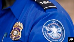 FILE - A Transportation Security Administration officer works at Dallas Love Field Airport on June 24, 2020, in Dallas. 