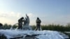 Firefighters spray foam on a wing of the Ural Airlines Airbus 321 passenger plane following an emergency landing in a field near Zhukovsky International Airport in Moscow Region, Russia, Aug. 15, 2019.