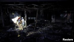 Firefighters stand at a scene of a fire, in Seongnam, South Korea, Jan. 3, 2025. 