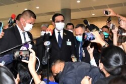 Thai Prime Minister Prayuth Chan-ocha talks to reporters at parliament after surviving a confidence vote, in Bangkok, Thailand, Sept. 4, 2021.