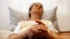 FILE - Alzheimer's disease patient Isidora Tomaz, 82, sits in an armchair in her house in Lisbon, Portugal, Sept.15, 2009. 