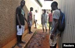 Residents gather to look at the footprints and traces of struggle, outside the house where an Italian volunteer lived before she was seized, in Chakama trading centre of Magarini, Kenya, Nov. 21, 2018.