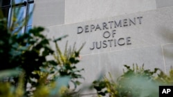 FILE - Signage marks an exterior wall of the U.S. Department of Justice Building in Washington, Jan. 23, 2023. 