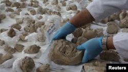 FILE - Conservators work on pieces of statues damaged by the Taliban, in National Museum of Afghanistan in Kabul, Afghanistan October 13, 2019. picture taken October 13, 2019.REUTERS/Omar Sobhani
