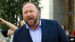 FILE- Far-right media personality Alex Jones speaks outside the Dirksen Senate Office Building in Washington, Sept. 5, 2018.