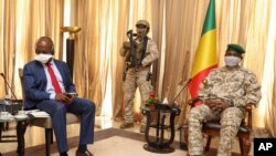 Kenya's Ambassador to the U.N. Martin Kimani, from Kenya, left, leads a United Nations Security Council mission meeting with Transition President Col. Assimi Goita, right, in Bamako, Mali, Oct. 24, 2021. 