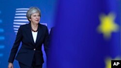 FILE - British Prime Minister Theresa May arrives for an EU summit in Brussels, Oct. 17, 2018. 