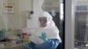 A laboratory specialist examines specimens of the Ebola virus at the Uganda virus research centre in Entebbe, 40km (25 miles) south from capital Kampala, May 17, 2011. 