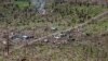 FILE - An aerial view of a coconut plantation and houses in a village destroyed by Typhoon Haiyan in Tolosa, Leyte in central Philippines, Nov. 19, 2013.