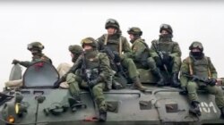 Belarusian peacekeepers ride an armored personnel carrier as they leave a Russian military plane at an airfield in Kazakhstan, Jan. 8, 2022, in this handout photo released by Russian Defense Ministry Press Service.