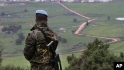 FILE - A Spanish U.N. peacekeeper looks to the U.N-demarcated Blue Line border between Lebanon and Israel, Feb. 24, 2015.