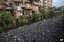 Garbage chokes a polluted canal in Mumbai, India, June 4, 2018.