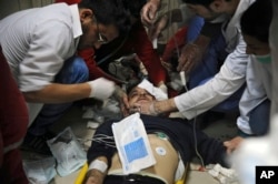 This photo released by the Syrian official news agency SANA shows a man receiving treatment at a hospital in Damascus, Syria, April. 7, 2018. State TV said Army of Islam fighters pelted several neighborhoods in Damascus with mortar shells, killing six civilians.