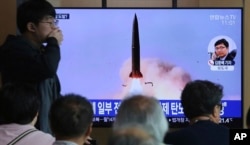 FILE - People watch a TV showing a news program reporting North Korea's missile launch, at the Seoul Railway Station in Seoul, South Korea, May 5, 2019.