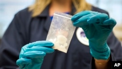 FILE - A bag of fentanyl seized in a drug raid is displayed at the U.S. Drug Enforcement Administration Special Testing and Research Laboratory in Sterling, Virginia, Aug. 9, 2016. High demand by U.S. drug users has made China a major exporter of the deadly synthetic substance.