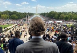 Rev. Al Sharpton, center, whose National Action Network organized the "Commitment March: Get Your Knee Off Our Necks" protest against racism and police brutality, arrives at the Lincoln Memorial in Washington, D.C.