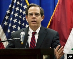 FILE - In this Oct. 1, 2015, photo, Stuart Jones speaks at a news conference at the U.S. Embassy in Baghdad, Iraq. The Trump administration is accusing the Syrian government of carrying out mass killings of thousands of prisoners and burning the dead bodies.