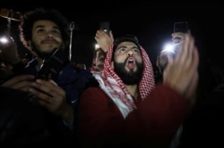 Protesters shout slogans during a protest against U.S. President Donald Trump's proposed Middle East peace plan, near the U.S. Embassy in Amman, Jordan, Jan. 28, 2020.