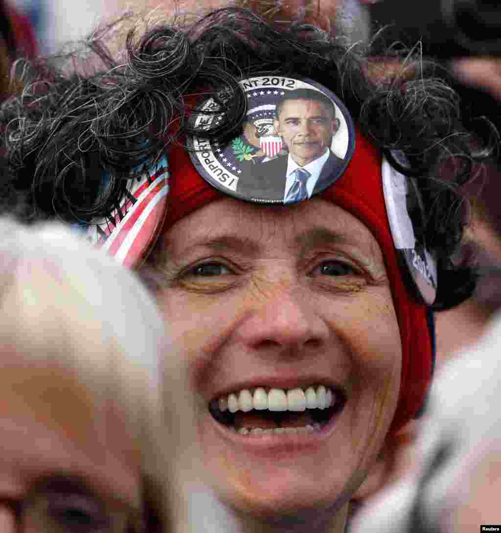 A supporter listens to President Obama at a campaign event at Austin Straubel Airport International Airport in Green Bay, Wisconsin, November 1, 2012. 