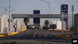 FILE - Cars exit the General Motors assembly plant in Villa de Reyes, outside San Luis Potosi, Mexico, Jan. 4, 2017.