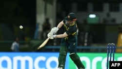 Australia's David Warner hits a six to score a half-century (50 runs) during the ICC men's Twenty20 World Cup 2024 Super Eight cricket match between Australia and Bangladesh at Sir Vivian Richards Stadium in North Sound, Antigua and Barbuda, on June 20, 2