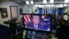 President Donald Trump is seen on monitors in the briefing room of the White House, as he gives a prime-time address in the Oval Office, Jan. 8, 2019.