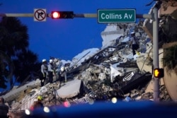 Rescue workers look through the rubble where a wing of a 12-story beachfront condo building collapsed, June 24, 2021, in the Surfside area of Miami.