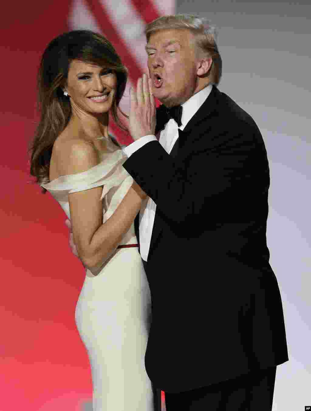 President Donald Trump gestures as he and first lady Melania Trump dance at the Freedom Ball in Washington, on Jan. 20, 2017, at the Washington Convention Center during the 58th presidential inauguration. 