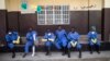 Health workers rest outside a quarantine zone at a Red Cross facility in the town of Koidu, Kono district in Eastern Sierra Leone, Dec. 19, 2014.
