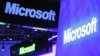 A variety of logos hover above the Microsoft booth on at the International Consumer Electronics Show in Las Vegas, January 10, 2012.