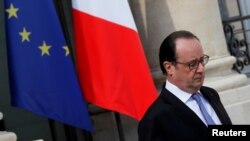 FILE - French President Francois Hollande leaves the Elysee Palace in Paris, July 15, 2016.