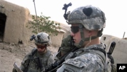 Soldiers from the U.S. 101st Airborne Division's 1st Battalion search a home in Senjeray, Kandahar province, Afghanistan, 7 Sept. 2010.